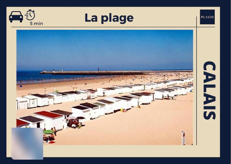 a beach with rows of umbrellas and people on it at AuKabest 3 * Proche ferry * Gare in Calais