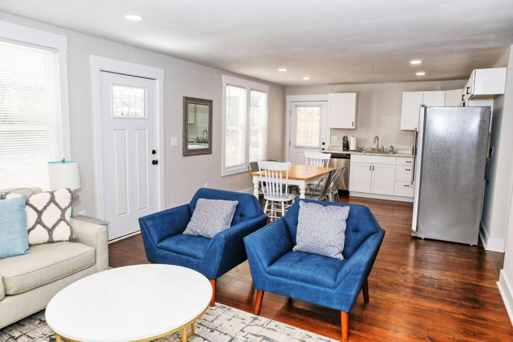 a living room with blue chairs and a kitchen at Sunny Hill Cottage with 4 Beds in Lincolnton