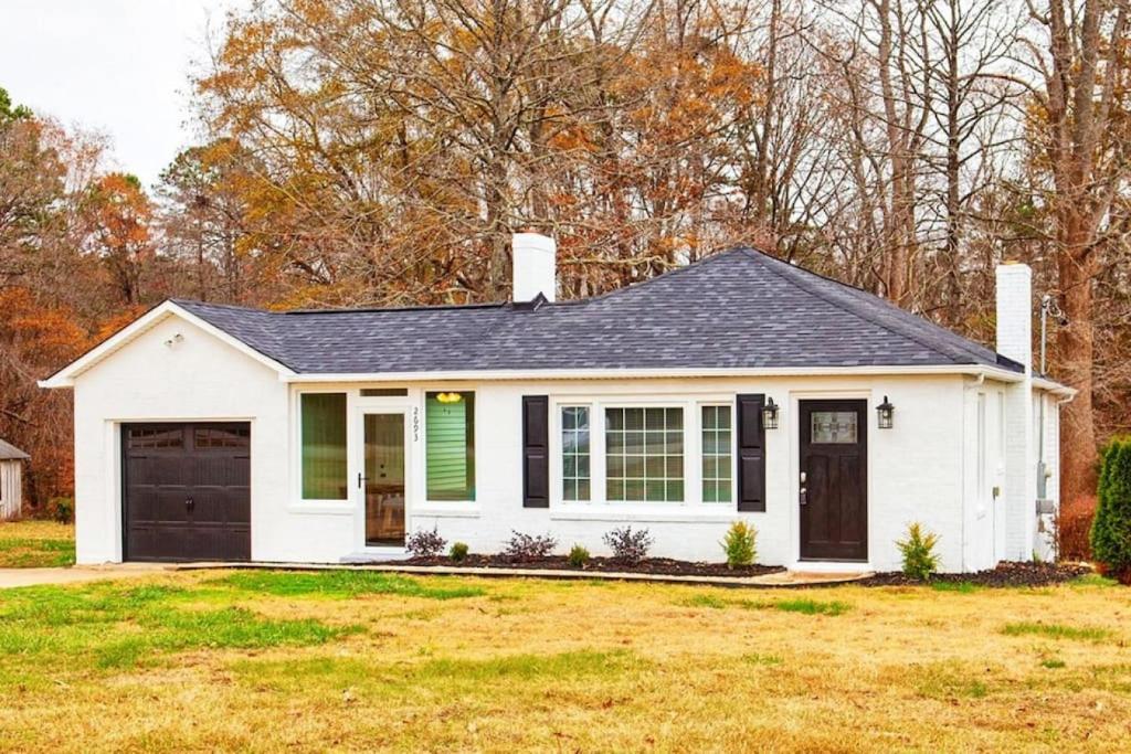 a white house with a black roof at Newly Renovated Salem Road Ranch in Lincolnton