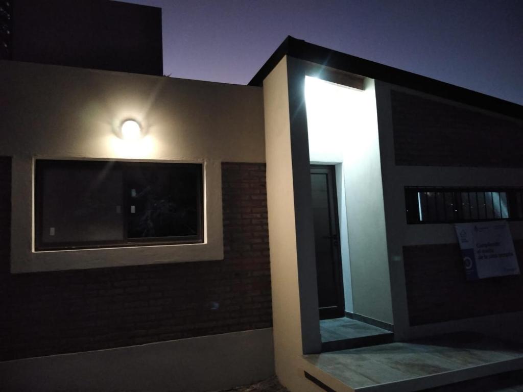 a room with a mirror and a light on the wall at La morada del arroyo in Villa Santa Cruz del Lago