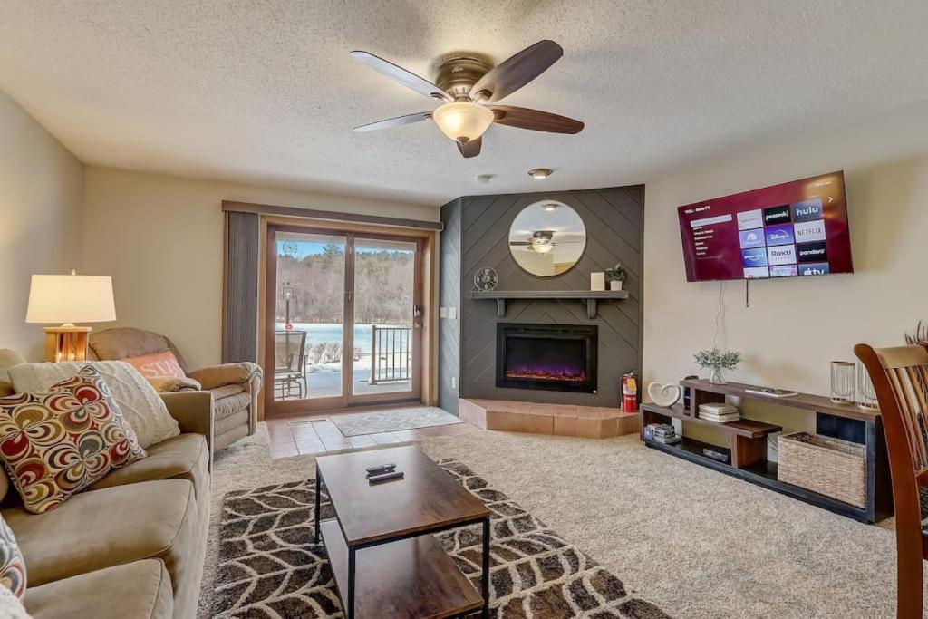 a living room with a couch and a fireplace at Stephs Waterfront Retreat Sunset Cove 303 in Wisconsin Dells