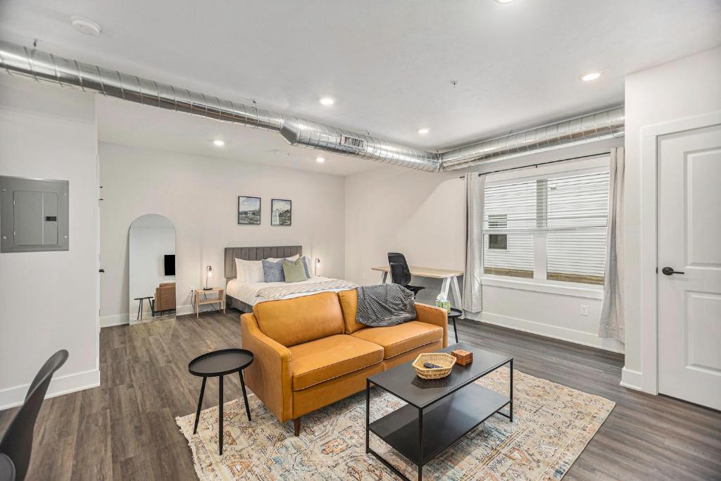 a living room with a couch and a bed at The Urban Oasis -brand New Corporate Apt Downtown in Grand Rapids