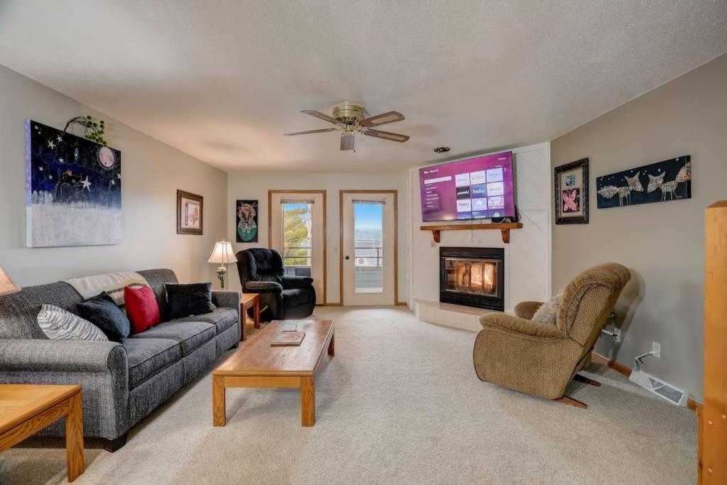 a living room with a couch and a tv at Wisconsin Dells Escape - Amazing Views - Pools in Wisconsin Dells