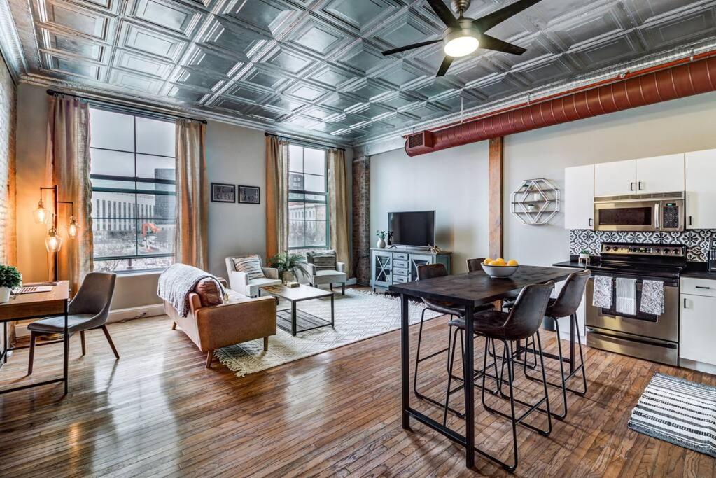 a large living room with a table and a kitchen at Good Vibes Loft - DT CLE Walk To All The Stadiums in Cleveland