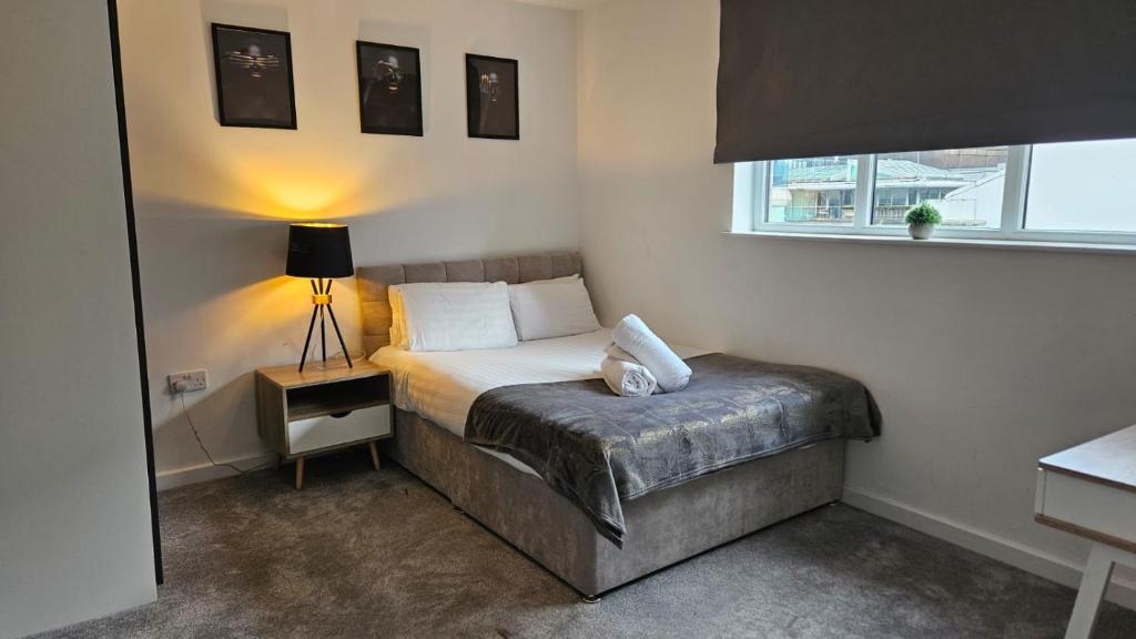 a small bedroom with a bed and a window at Families And Contractors Welcome! Central Beauty in Liverpool