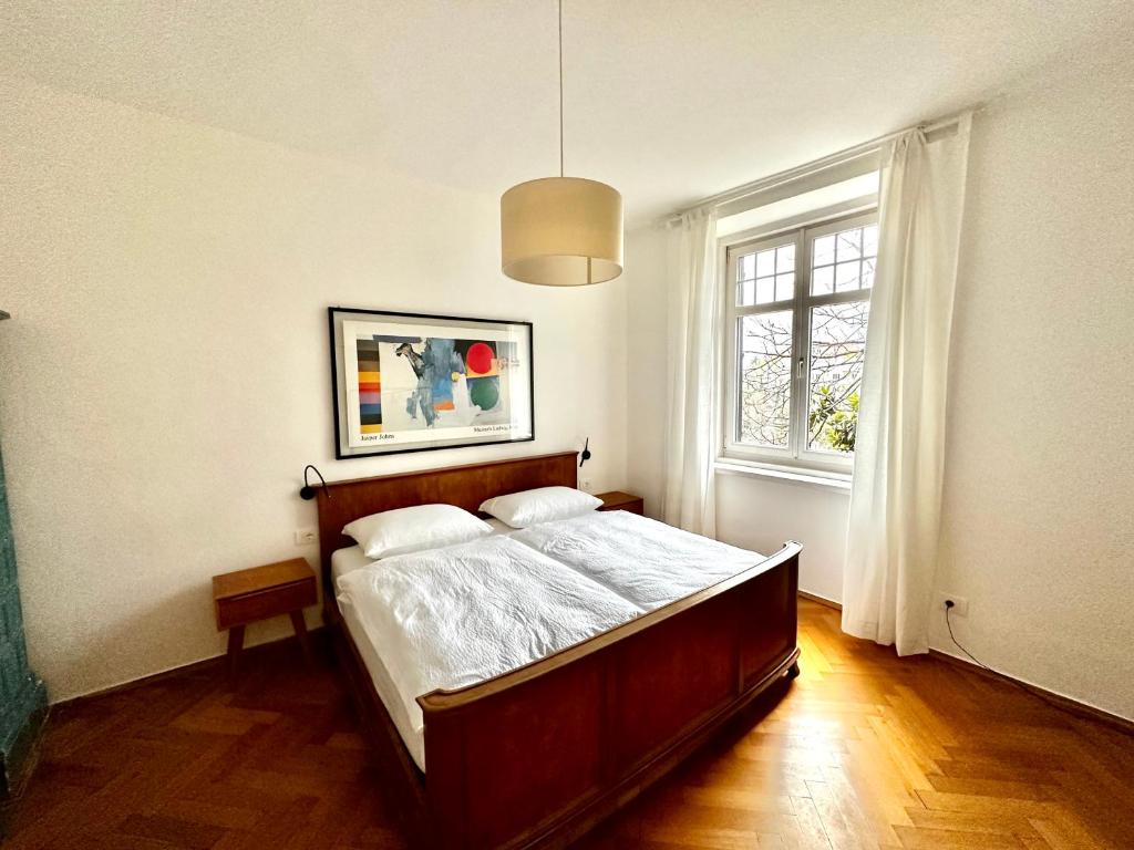 a bedroom with a bed and a window at Baker House in Bolzano