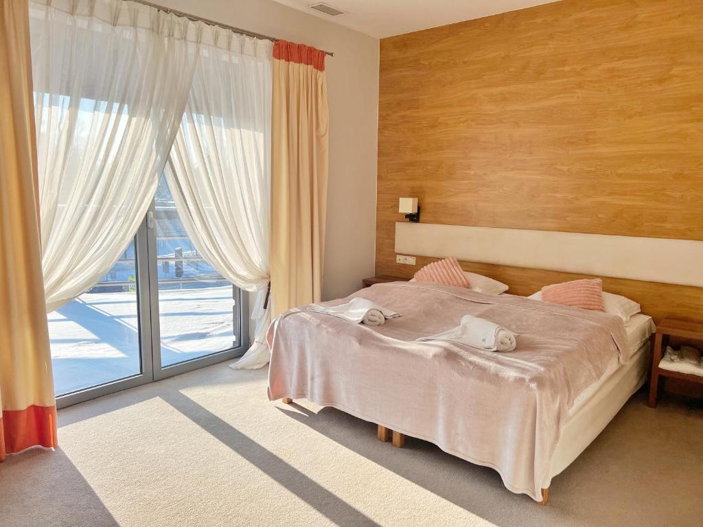Postel nebo postele na pokoji v ubytování Symfonia