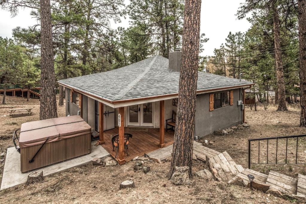 a small house in the middle of the woods at Peak In The Pines in Ruidoso