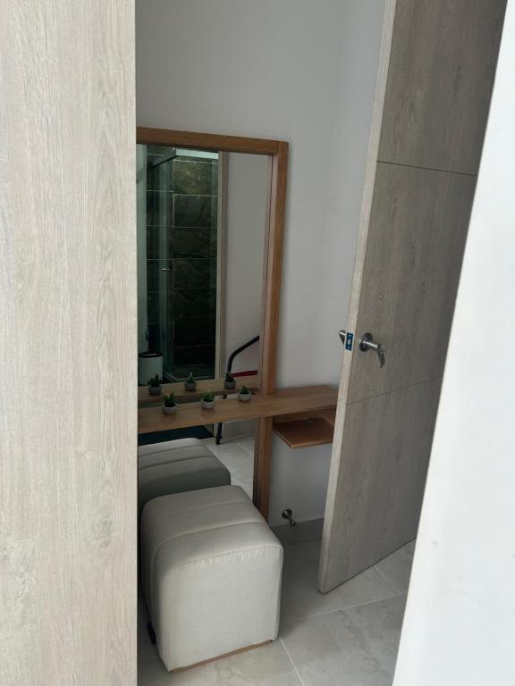 a room with a door and a stool and a mirror at Habitación con baño Privado in Envigado