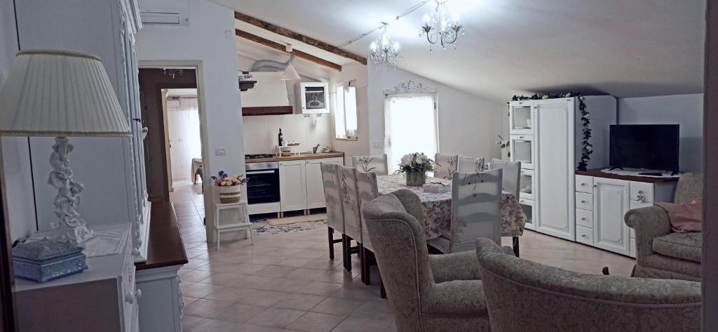 a kitchen and living room with a table and chairs at DIMORA MAJELLA in Chieti