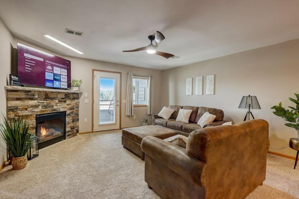 a living room with a couch and a fireplace at Lakefront Haven for Families Golfers and Girls Trips in Wisconsin Dells