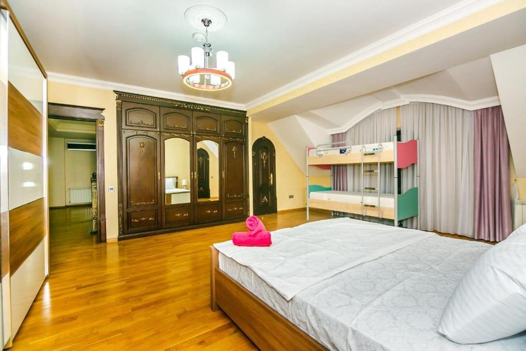 a large bedroom with a large bed and a pink toy at VIP Apartment PARMALAT in Baku