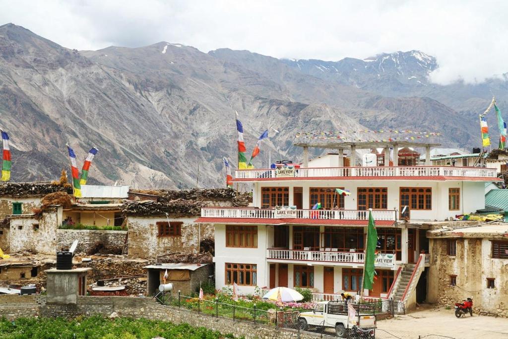 a building with flags on top of a mountain at Hotel Lake view in Nako