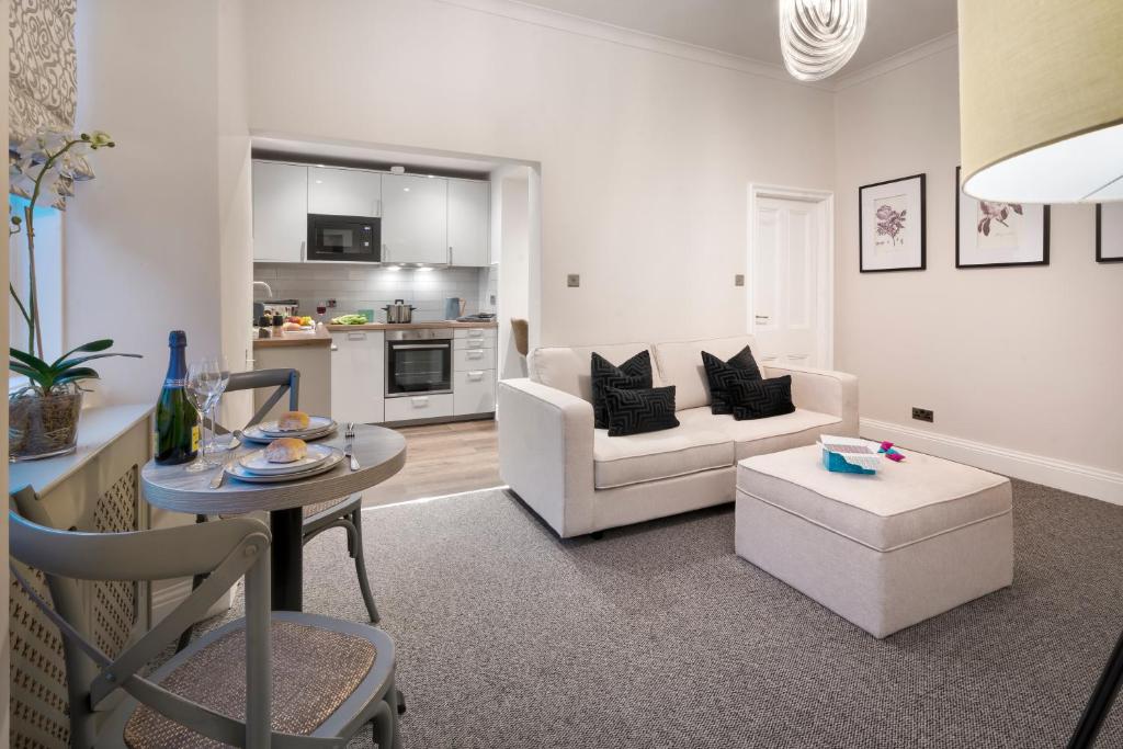 a living room with a couch and a table at One Merewyke in Bowness-on-Windermere