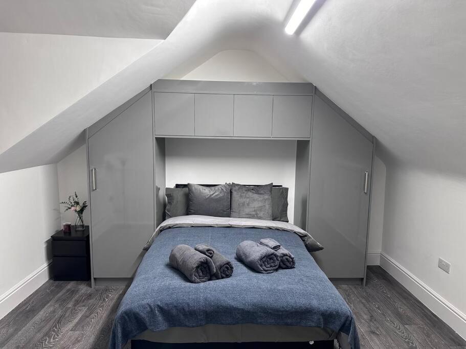 a bedroom with a bed with two pillows on it at Home in Leicester! in Leicester