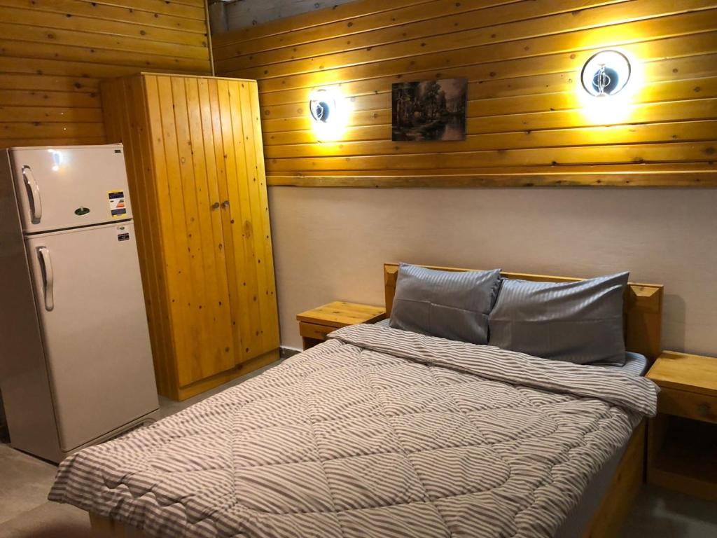 a bedroom with a bed and a refrigerator at Ayana Hotel Dahab in Dahab