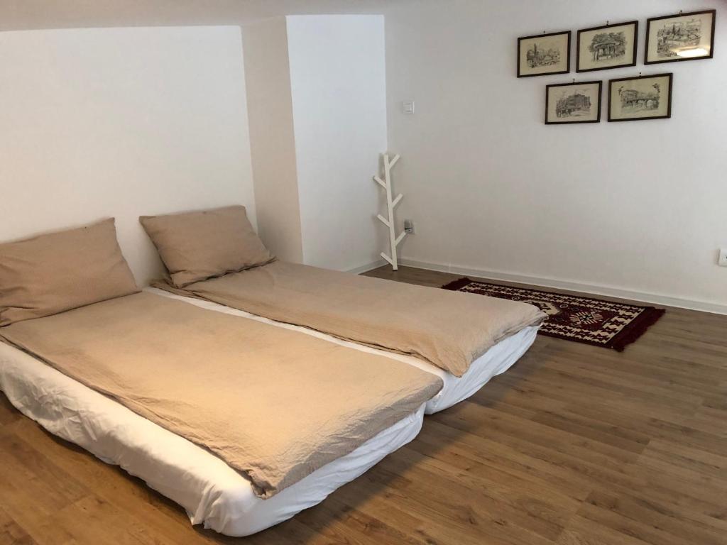 a bed sitting in a room with at Apartman Bjelasnica - vila Smuk in Bjelašnica