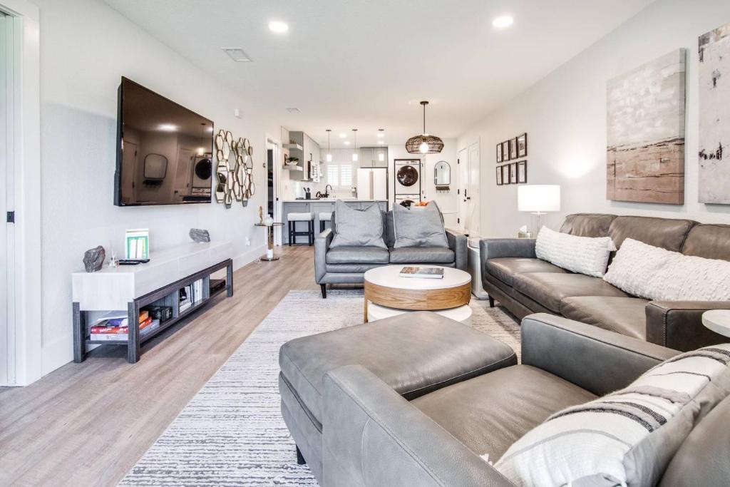 a living room with a couch and a tv at Matchless Luxury III on Mill Pond - 3168-3170 in Wesley Chapel
