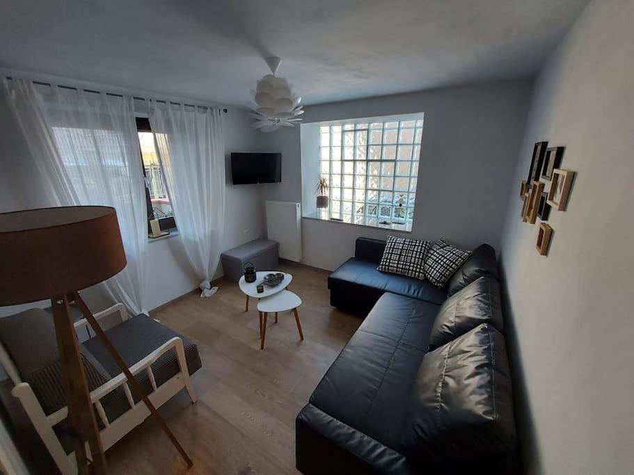 a living room with a couch and a table at Ισόγειο διαμέρισμα με κήπο. Special design! in Kastoria