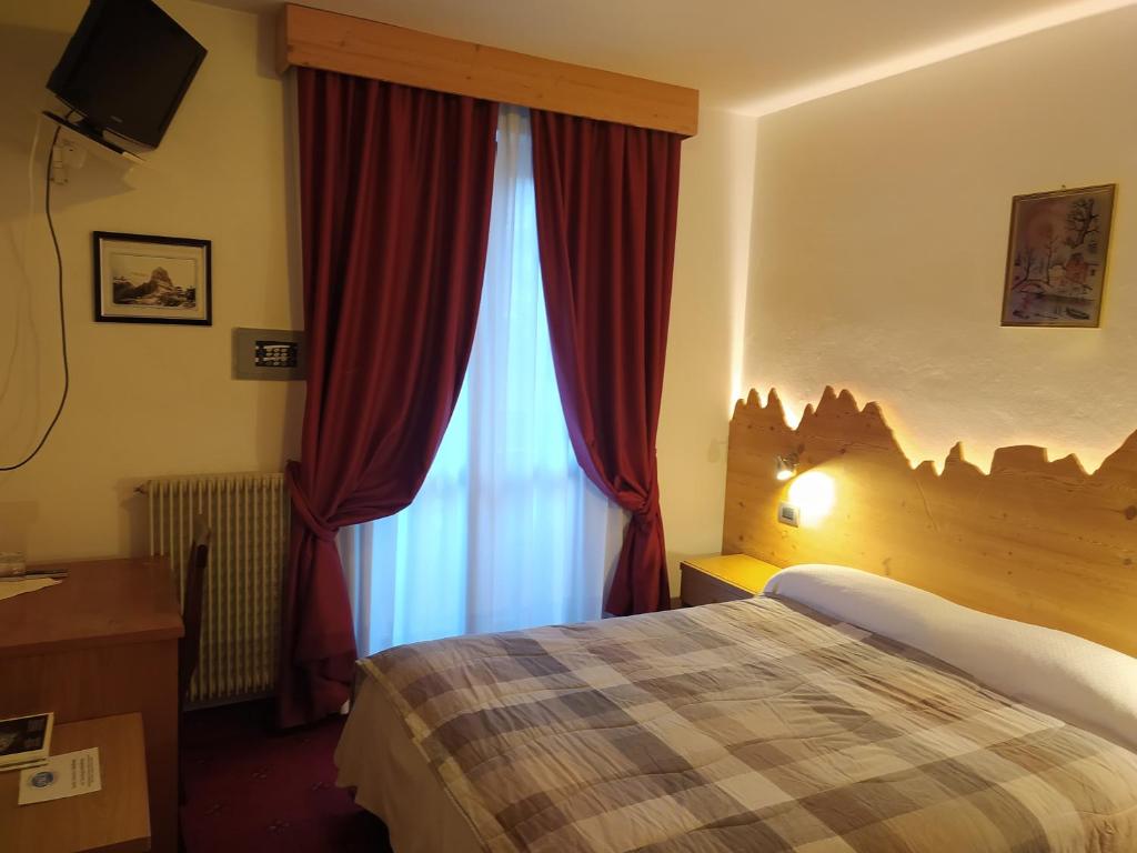 Postel nebo postele na pokoji v ubytování Hotel Orso Grigio