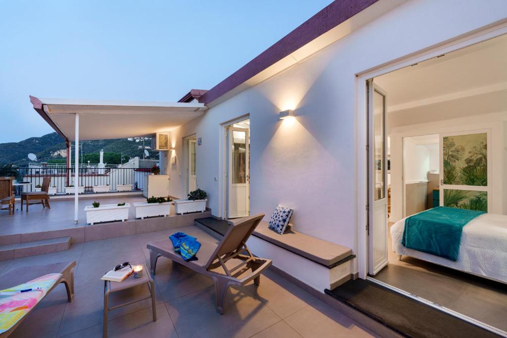 a room with a balcony with a bedroom and a bed at Enfasi Holiday Home in Vico Equense