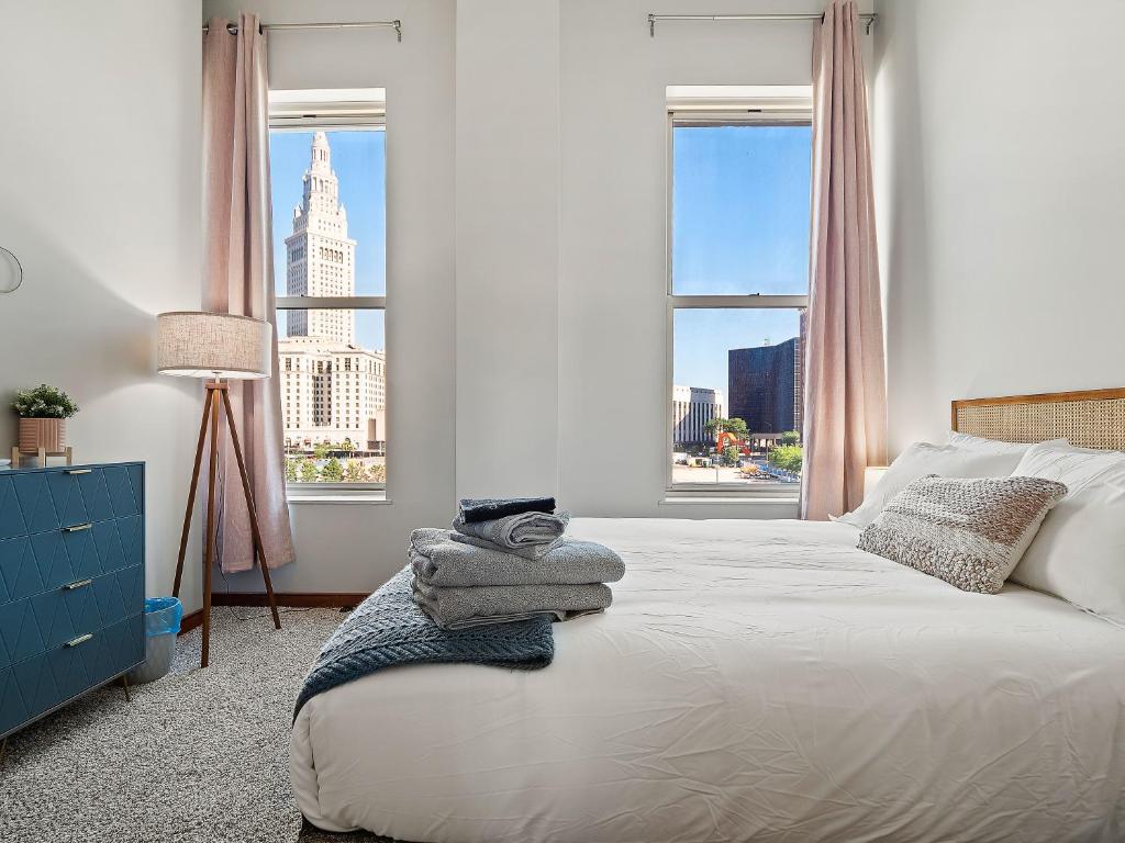 a bedroom with a bed with a view of a building at Downtown Condo in Cleveland