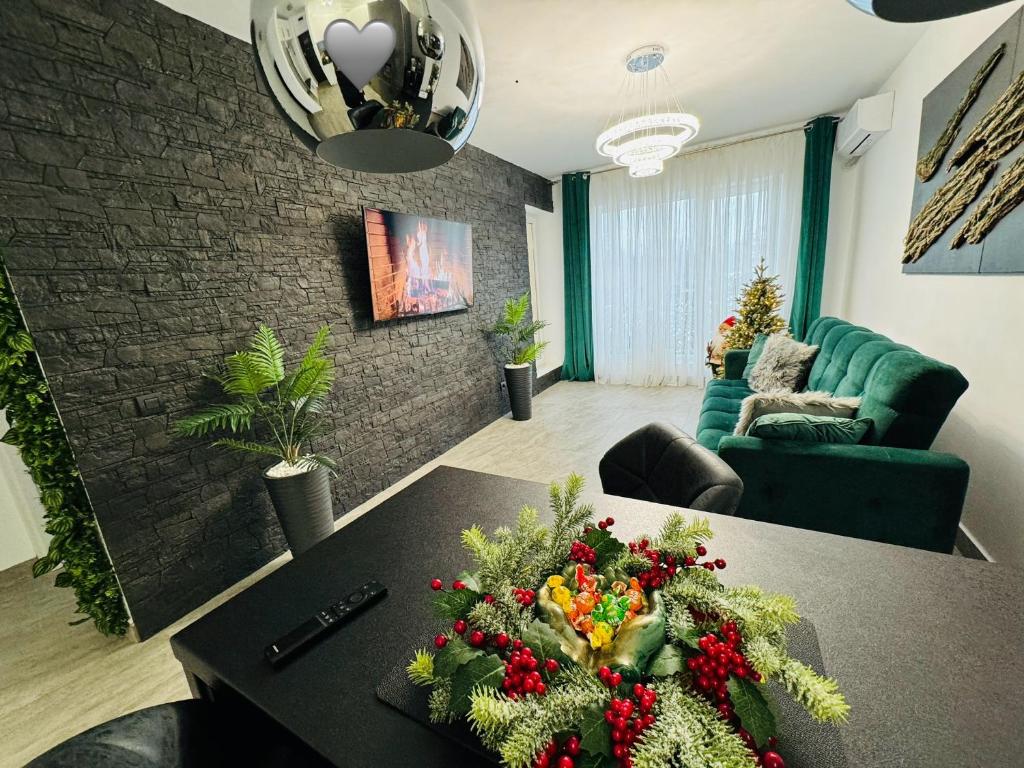 a living room with a table with a christmas arrangement on it at Aici te simți ca acasa in Iaşi