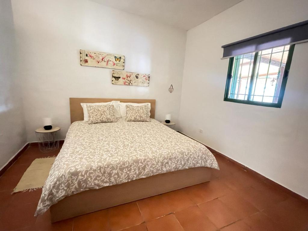 a bedroom with a bed and a window at Bed&Ride La Manigua in Ojos de Garza