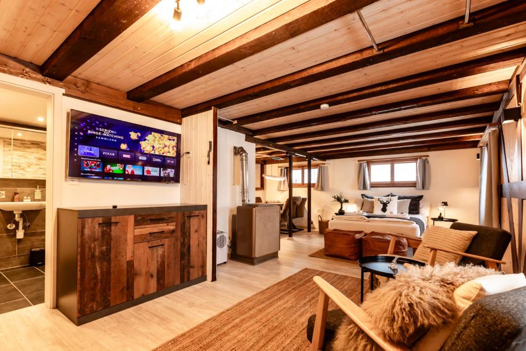 TV a/nebo společenská místnost v ubytování INN JOY Apartments - Flumserberg mit Bergpanorama