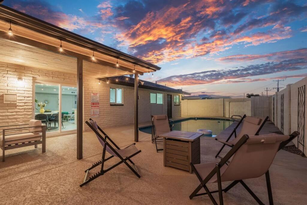 a patio with chairs and a swimming pool at New-5 Star Sunset Views l Amazing Pool -Short & Long stays l GCU in Phoenix