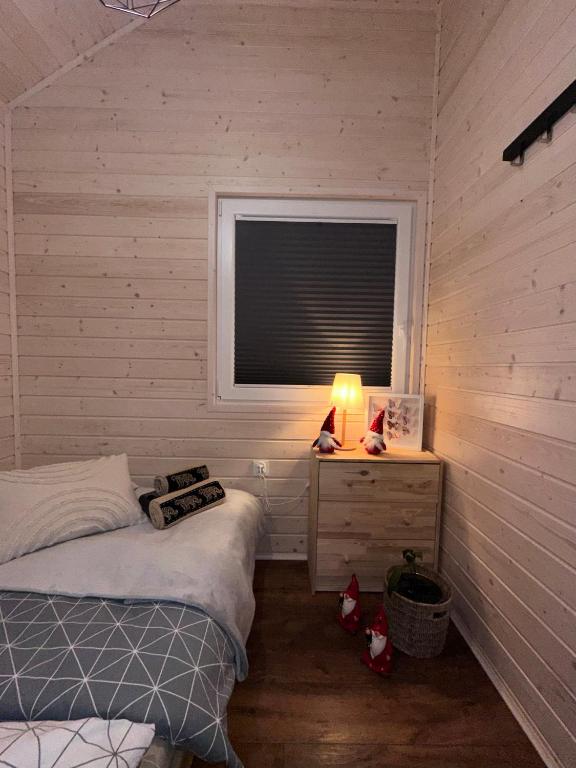 Cozy bedroom with lamp-lit nightstand and decorative items.