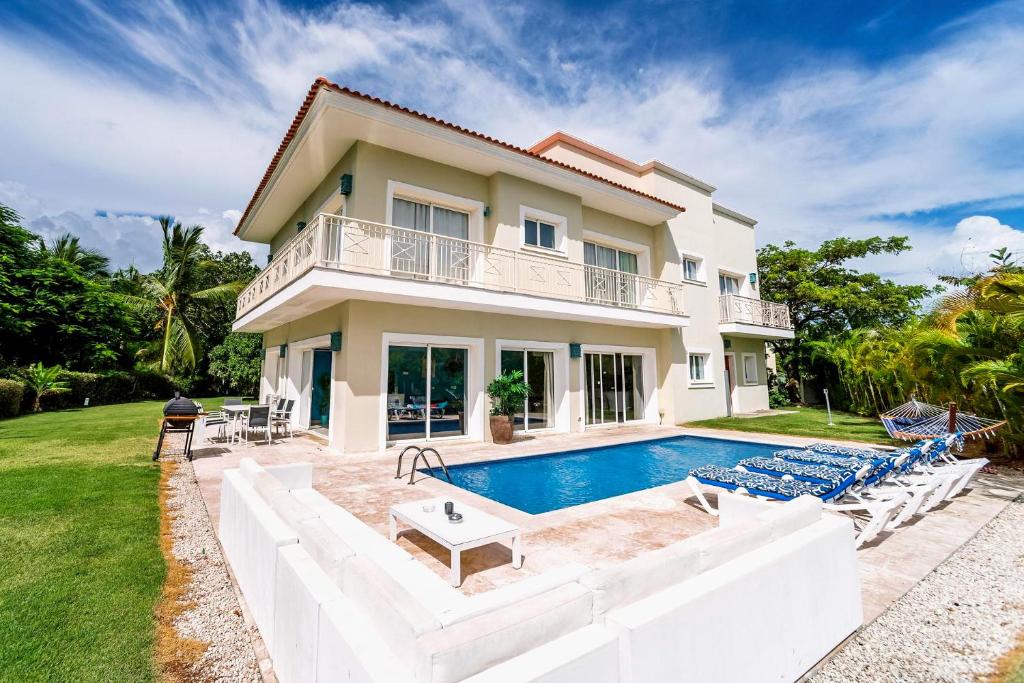a villa with a swimming pool and a house at Special offer! Villa Bueno with private pool&beach in Punta Cana