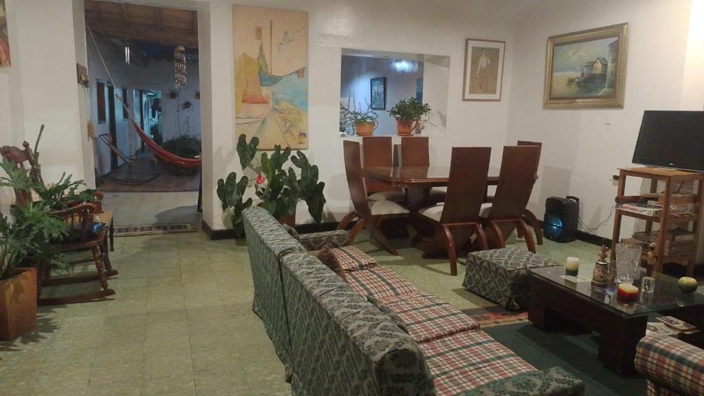 a living room with a couch and a dining room table at Casa La Plazuela in Curití