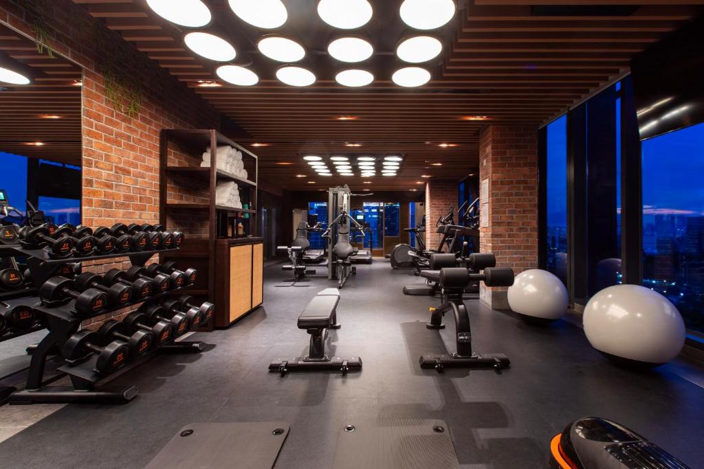 A well-equipped gym offers free weights, benches, resistance machines and large windows.