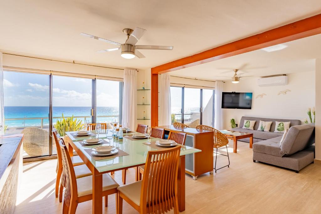 uma sala de jantar e sala de estar com mesa e cadeiras em Amazing Caribbean Ocean view at Villas Marlin in Cancun em Cancún