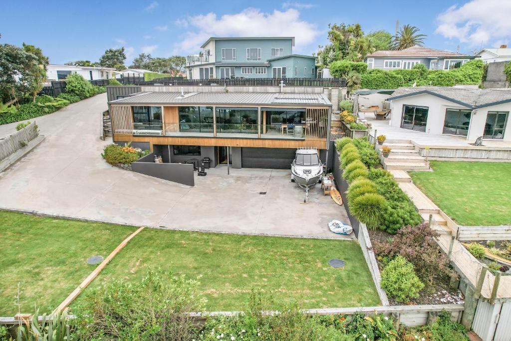 an aerial view of a house with a backyard at Upper Bow Retreat - Raglan Holiday Apartment in Raglan