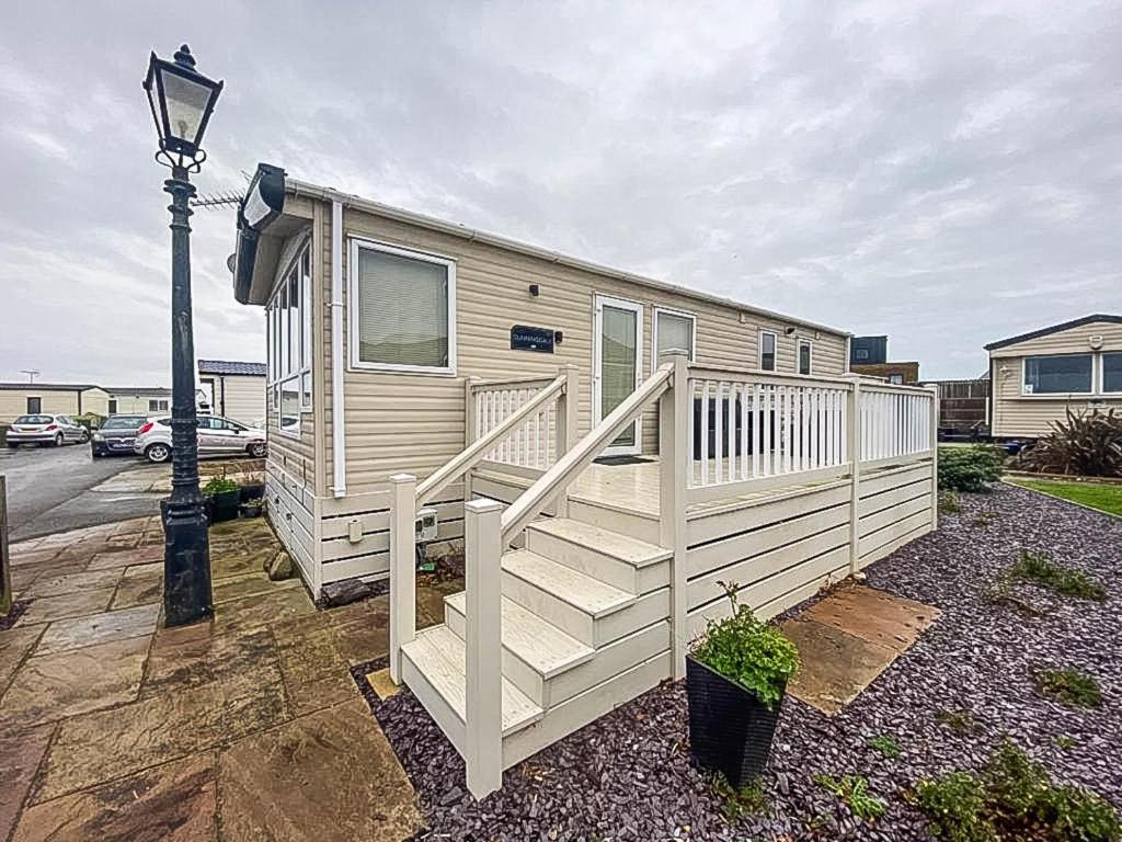 a mobile home with a staircase and a street light at Lovely 6 Berth Caravan With Decking And Wifi In Kent, Ref 47017c in Whitstable