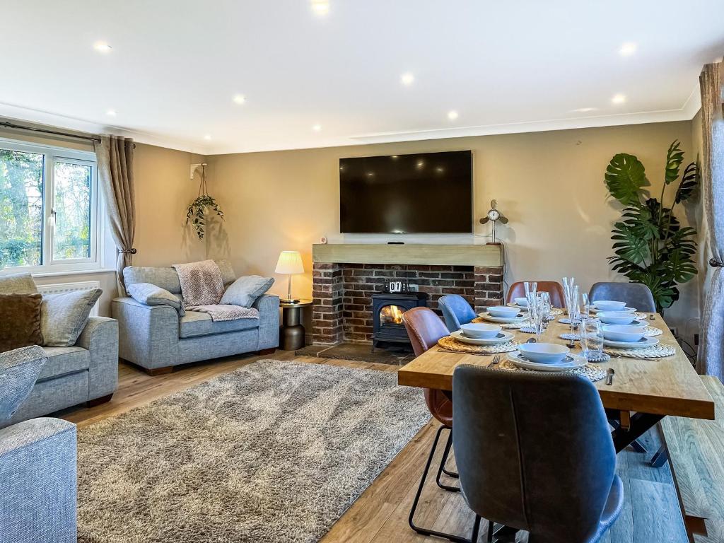 a living room with a table and a fireplace at Bridge Farm in Uttoxeter