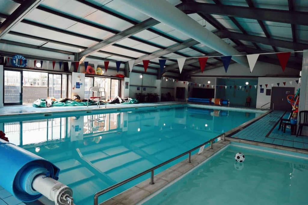 a large swimming pool with a soccer ball in it at Melrose in Leysdown-on-Sea