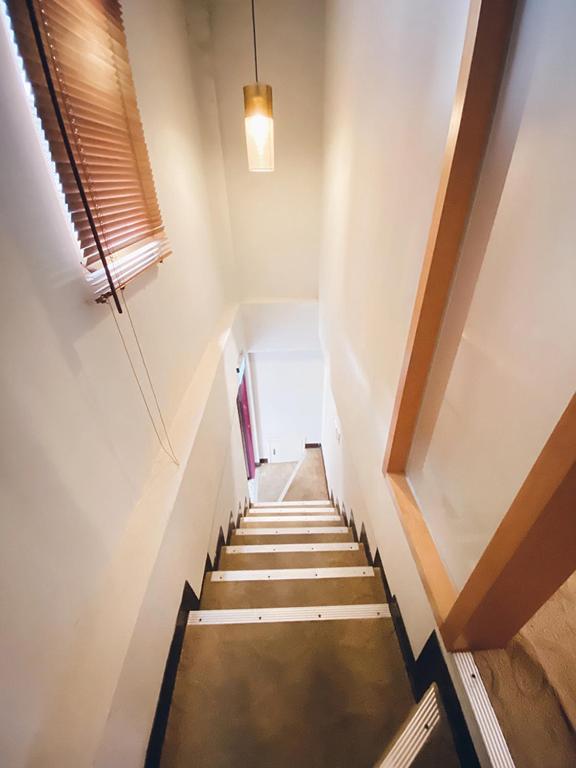 a staircase leading up to a room with a window at JinShan Sakura Bay Hot Spring Hotel in Jinshan