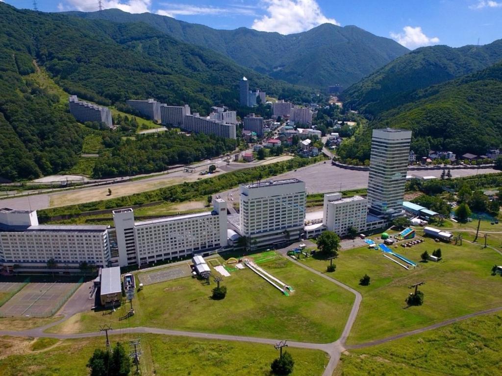 an aerial view of a city with mountains in the background at Naeba Prince Hotel in Yuzawa