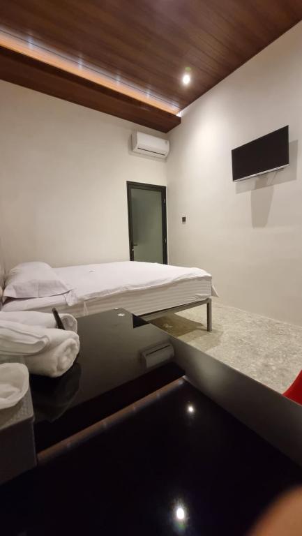 Postel nebo postele na pokoji v ubytování Uni Inn Semarang - Gunung Pati