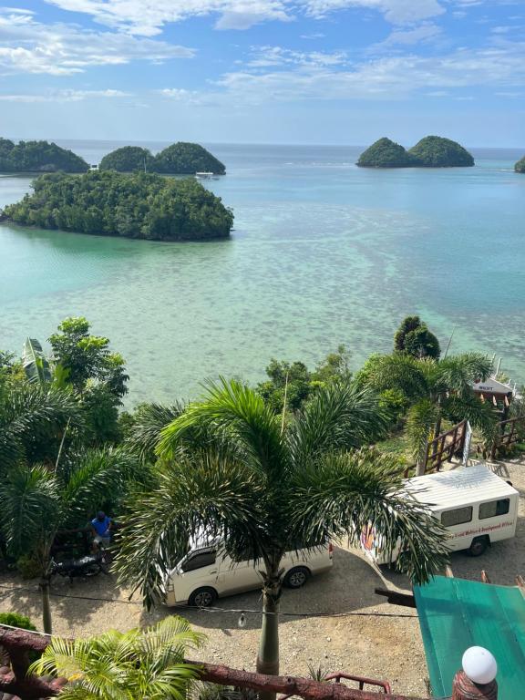 an island in the water with a van parked next to it at C View Resort in Sipalay