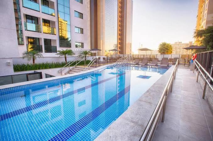 a large swimming pool in a hotel with buildings at Flat hotel Athos Bulcão. in Brasilia