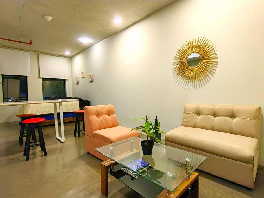 sala de estar con sofá y mesa en 906A URBN Barrio Escalante Estudio con A/C y Parqueo, en San José