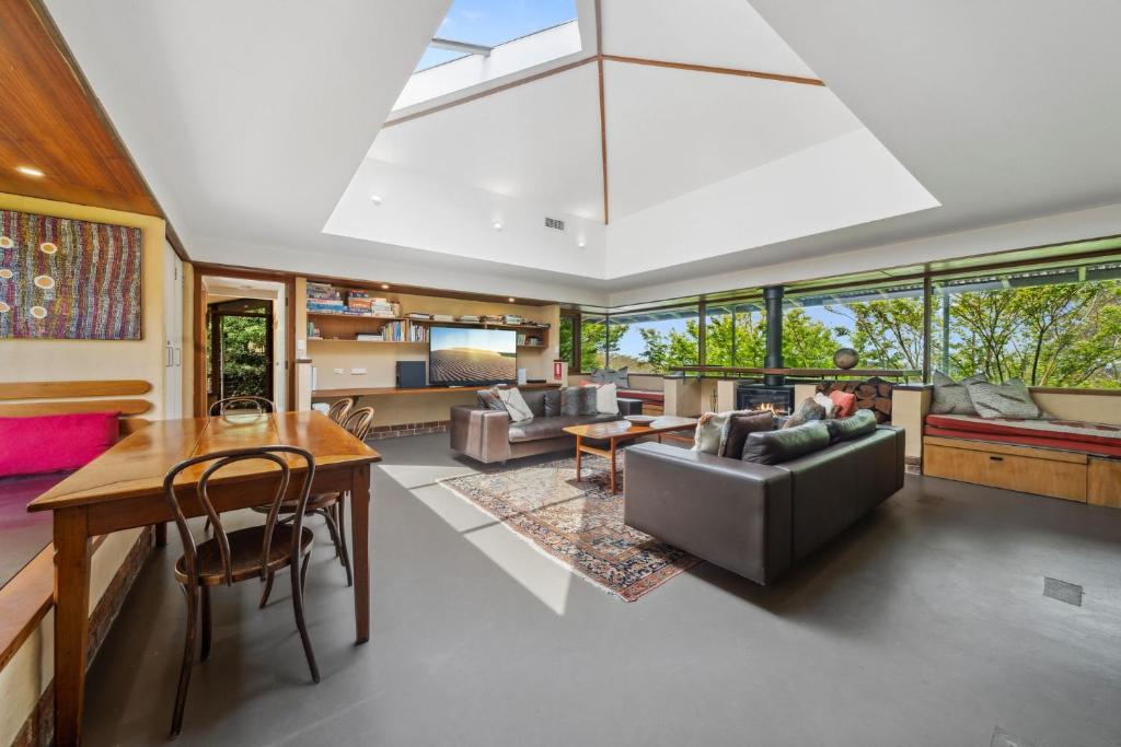 a living room with a couch and a table at Summer House in Wentworth Falls