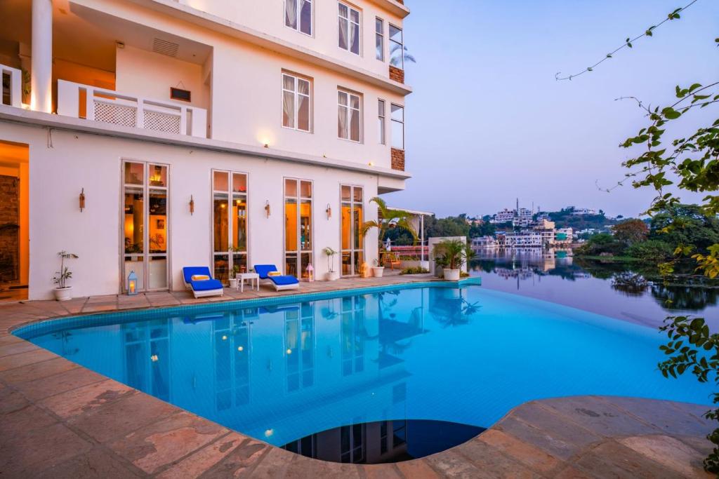 a swimming pool in front of a building at Moustache Udaipur Verandah in Udaipur