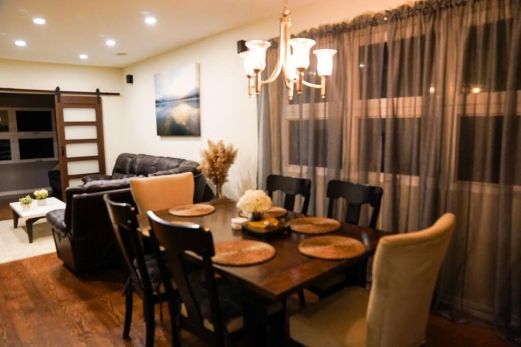 a dining room with a table with chairs and a couch at Nice and cozy. Sleeps 5. in Chicago