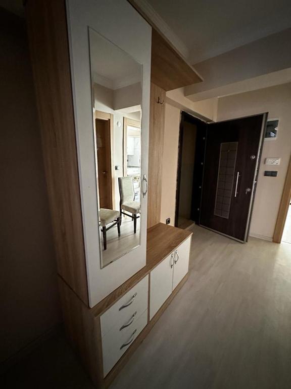 a living room with a mirror and a chair at Ecemsuit2 in Yomra