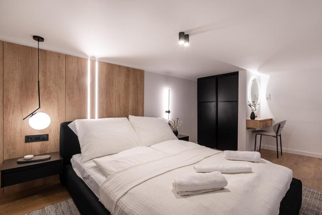 a bedroom with a large bed with two towels on it at E56 Queen's Boutique Apartment,best Location by BQA in Budapest